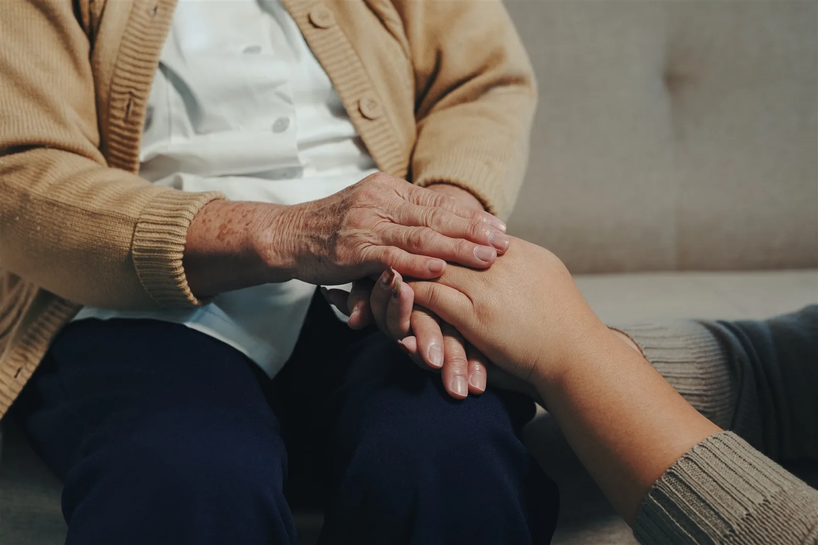 Hands held together in comfort