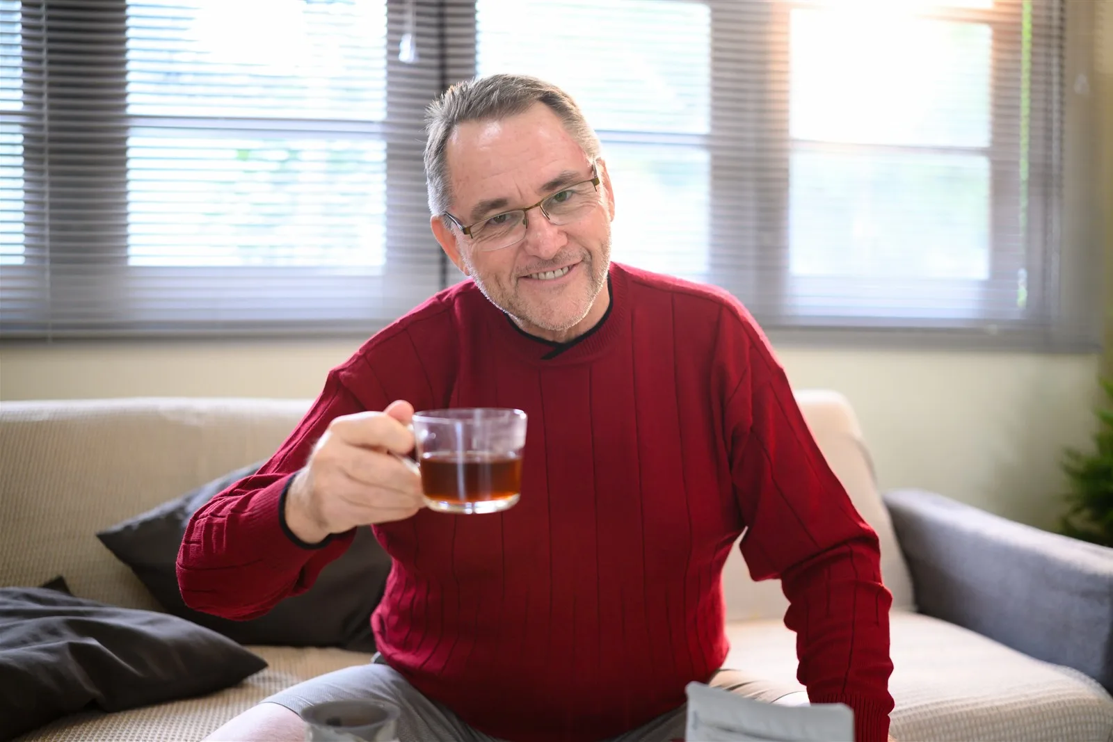 Home Care or a Care Home? How to Decide What’s Right Older man relaxing at home with a hot drink