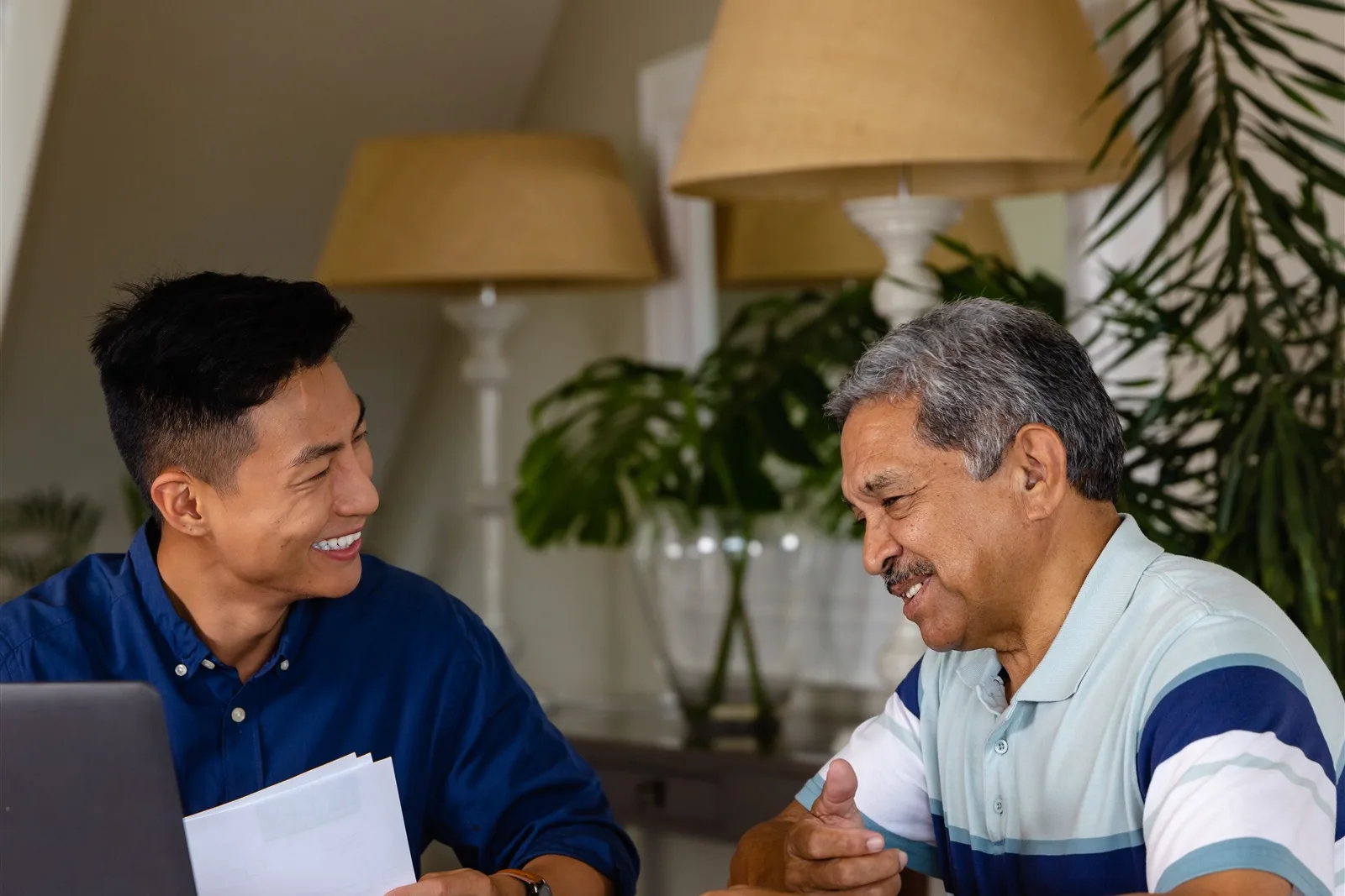Older man and younger man going through paperwork at home